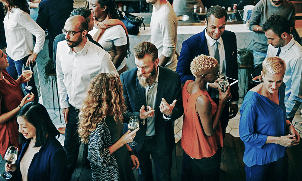 Image of attendees socializing at conferences for conference playlist