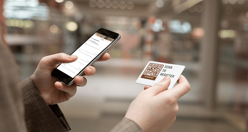 Photo of phone scanning QR code for wireless technology, event technology like RFID, QR codes, and 5G network