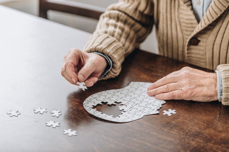 Person putting puzzle of brain together