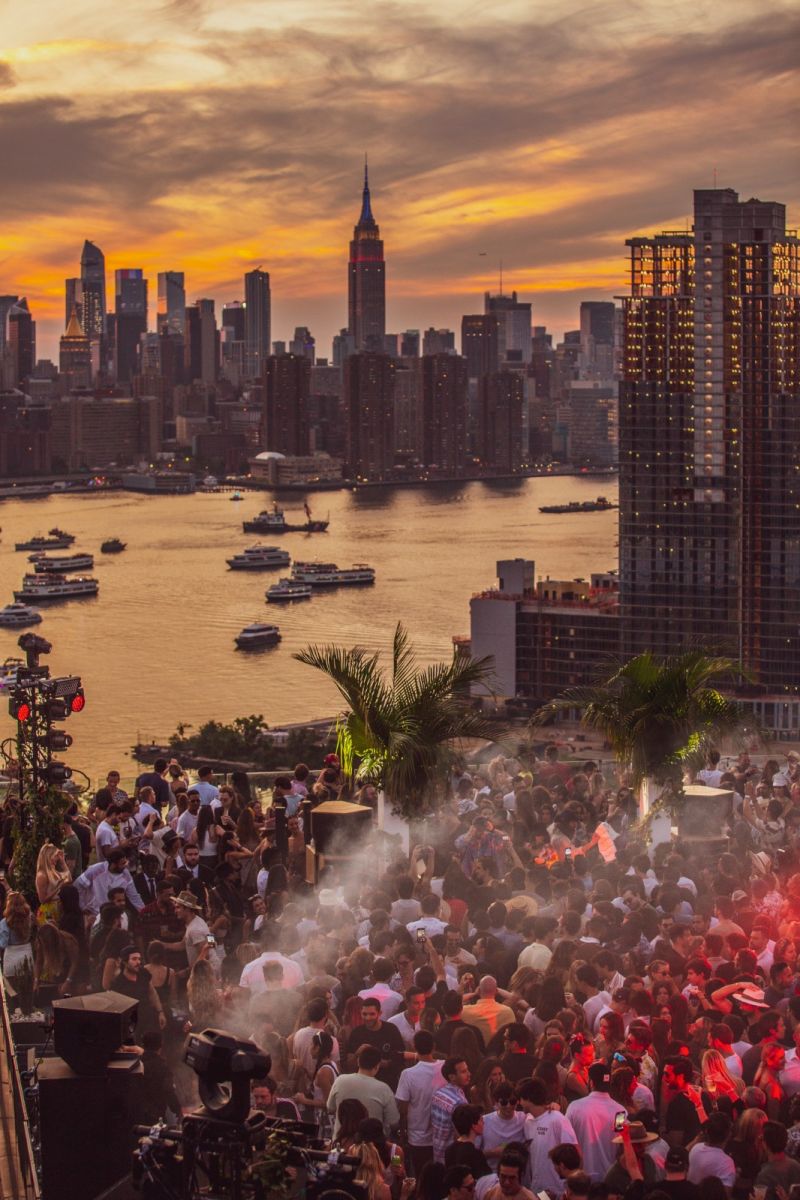 Rooftop party at sunset with skyline view