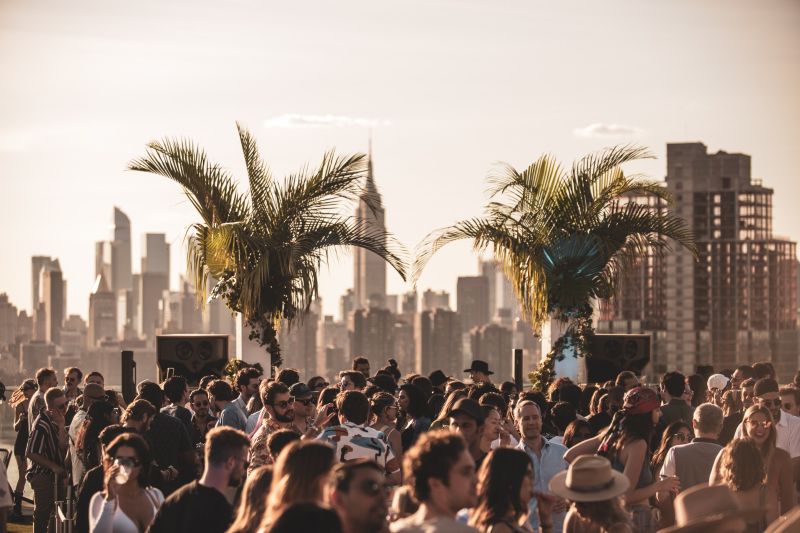 Rooftop party at sunset with skyline view